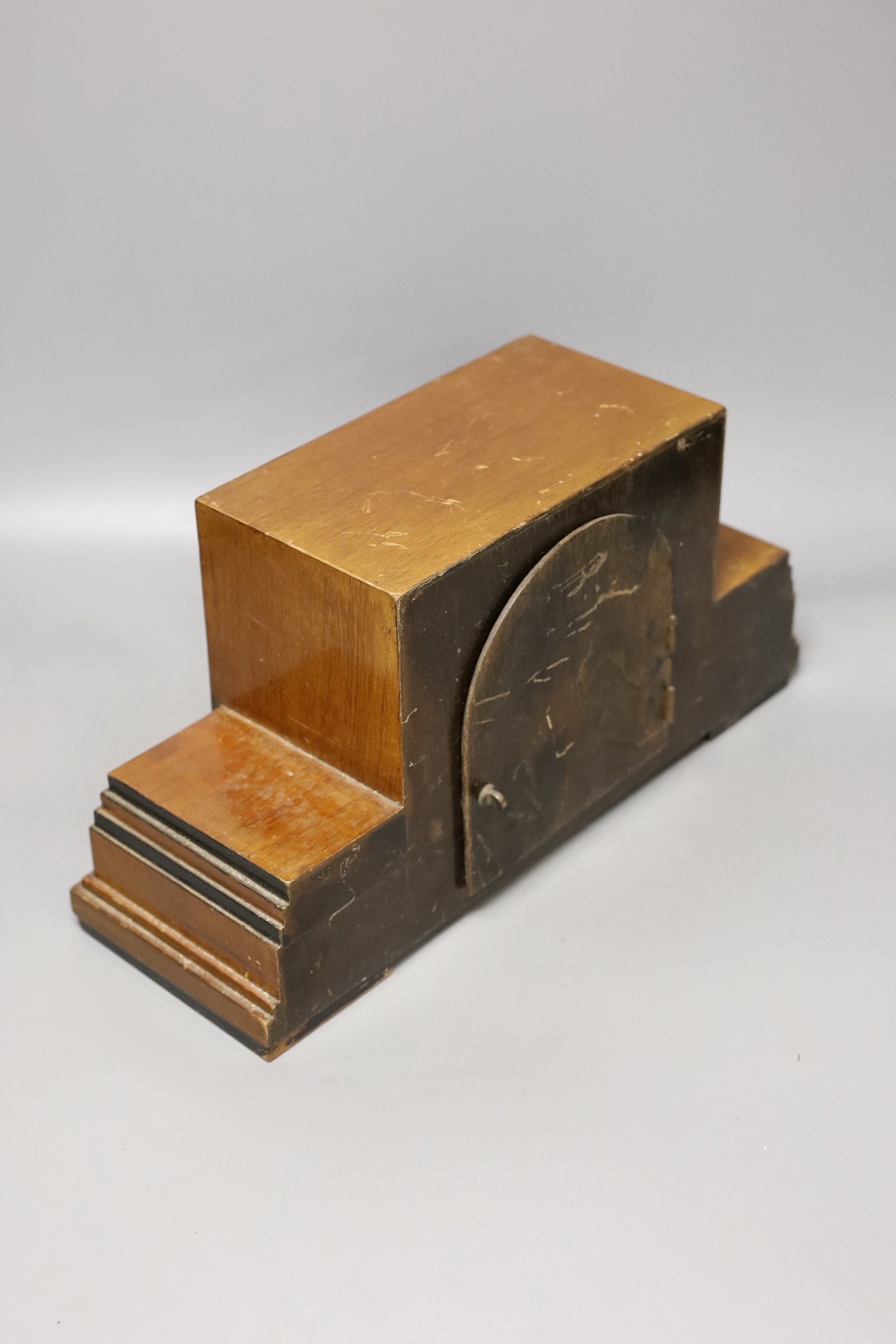 An Art Deco walnut mantel clock, 38 cms wide.
